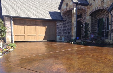 a brown stain applied to a concrete driveway for an instant transformation