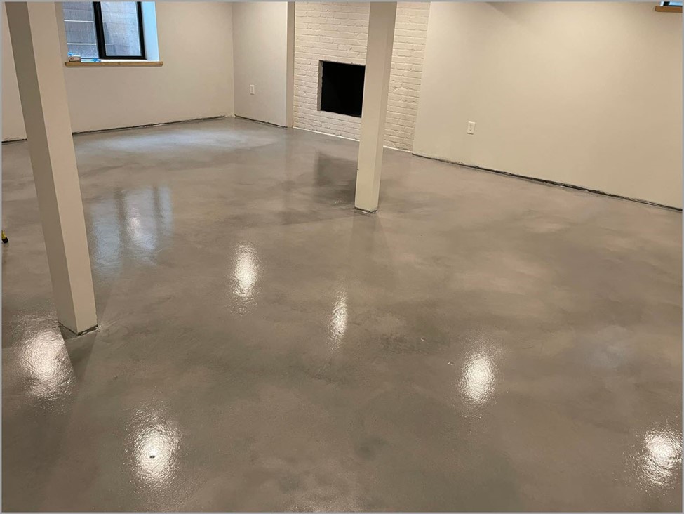 Light brown stained concrete floor inside a home basement