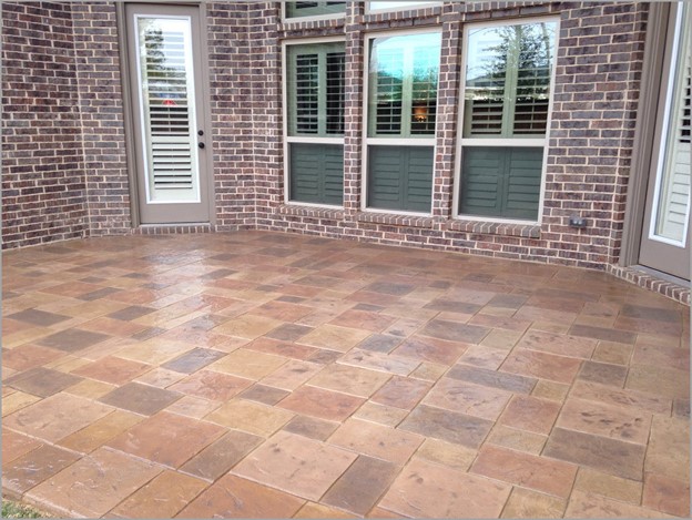 square checkerboard stamped concrete patio of a home