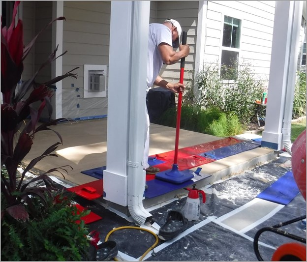 Concrete Craft employee working on a patio with stamps to show no heavy equipment is used with Concrete Craft resurfacing techniques